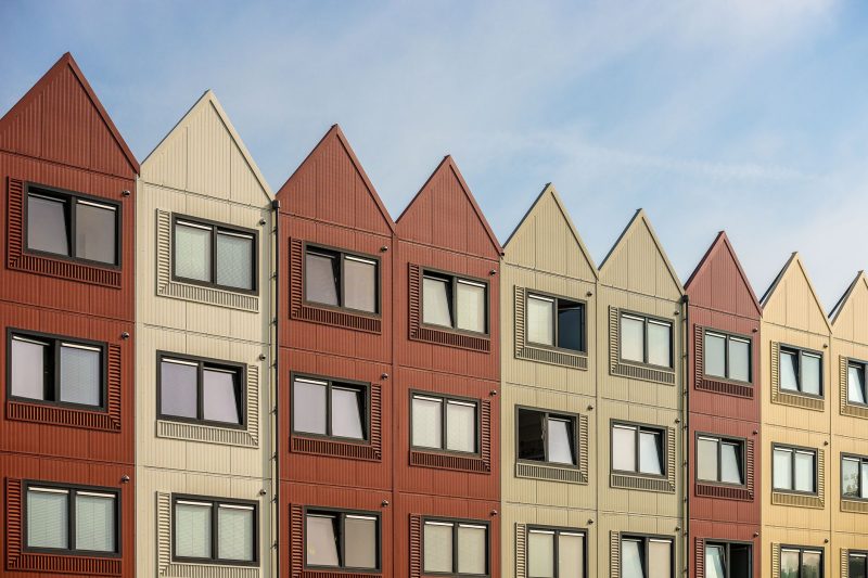 Home 11 A vibrant row of gableroofed residential buildings with meta 1782838821